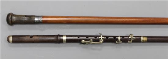 A rosewood walking stick with flute handle, 34.5in.